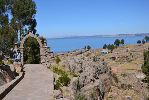 stradina pavimentata con al termine un arco di pietra e il lago all’orizzonte